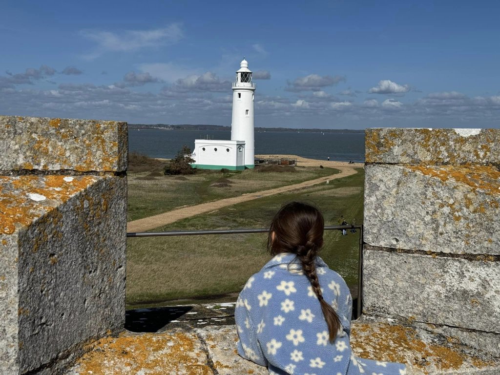 Girl looking at the lighthouse from Hurst Castle, Milford on Sea