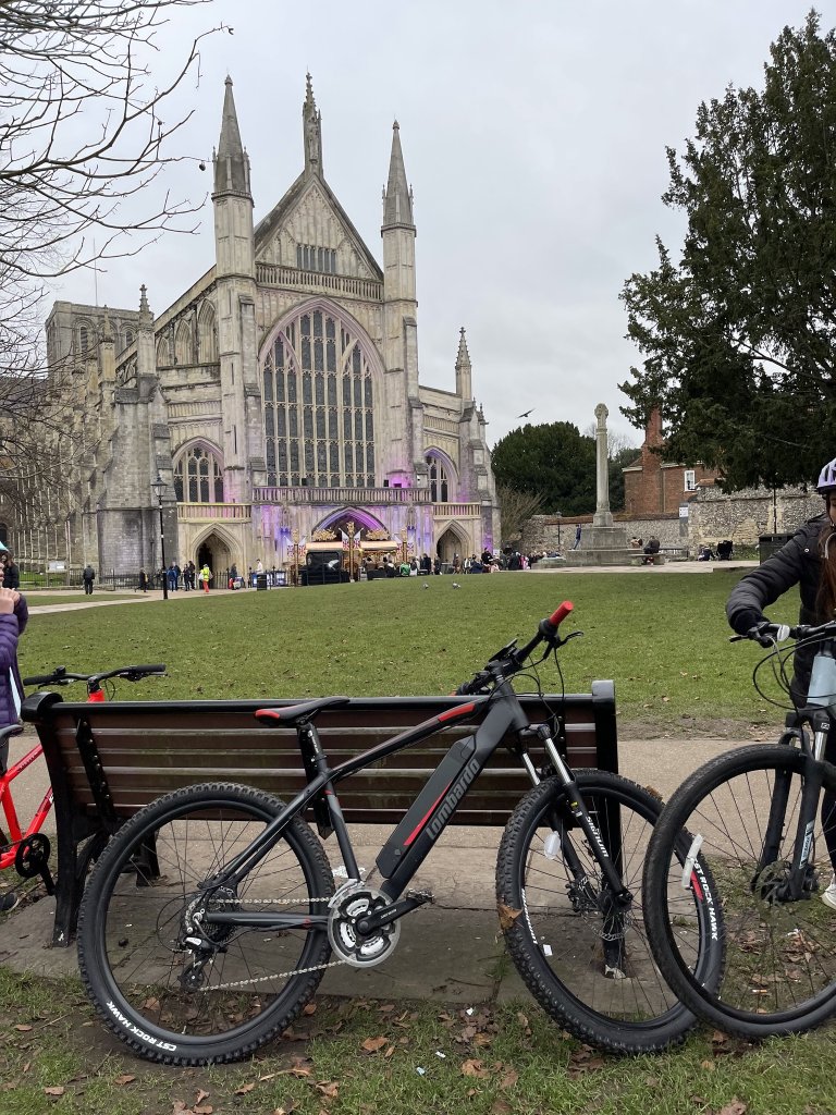 bike against a bench in front of winchester cathedral