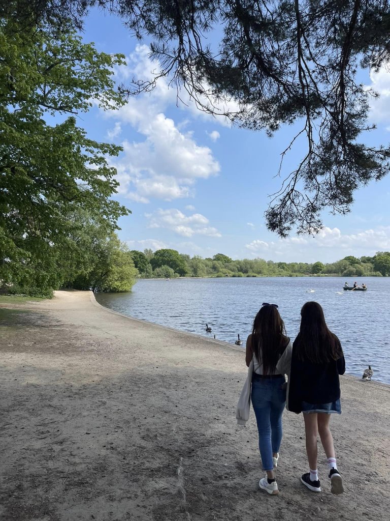 Woman and young girl standing looking at the lake