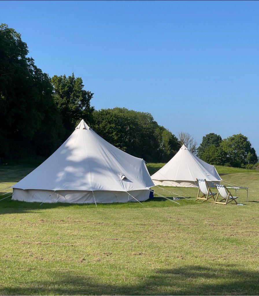 two bell tents on a camping site