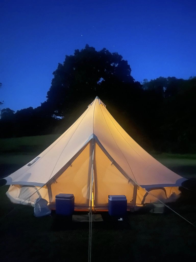 a lit bell tent at night
