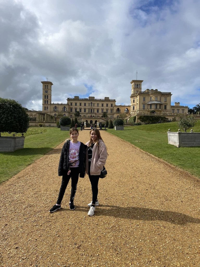 a mum and daughter standing in front of Osbourne House