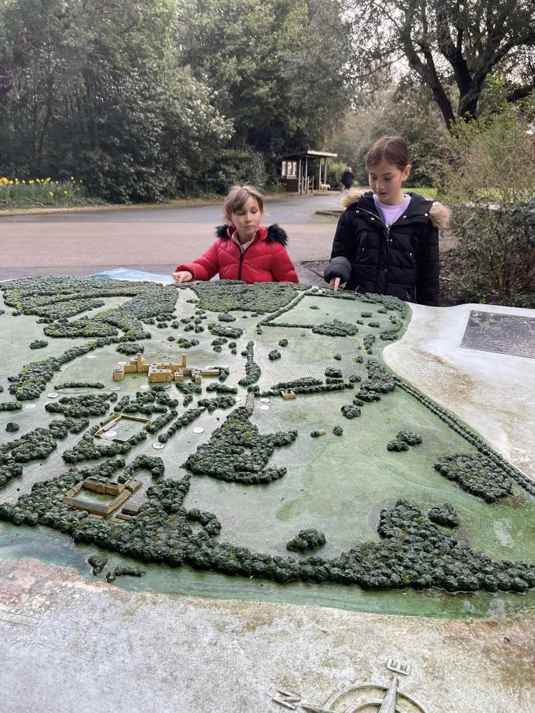 Two girls looking at a miniature of Osbourne House and Gardens