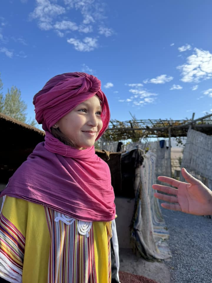 young girl with a pink headscarf