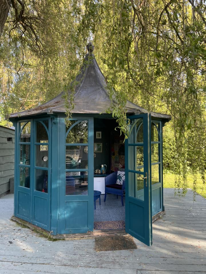 closed gazebo with table and chairs inside
