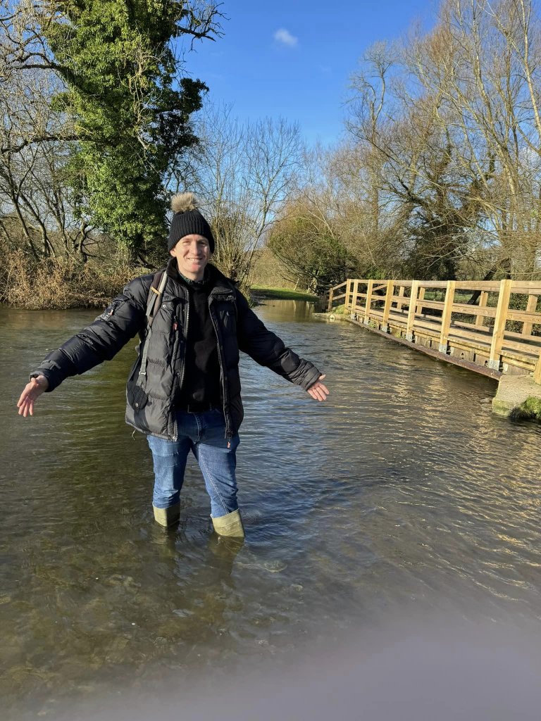 Man knee-deep in flood water