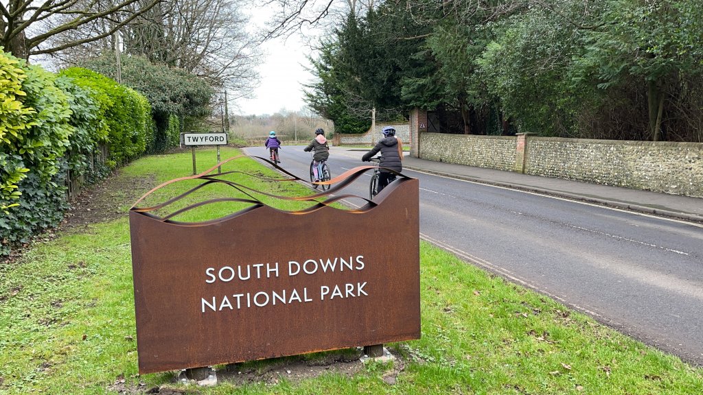 Cycling past the south downs national park sign